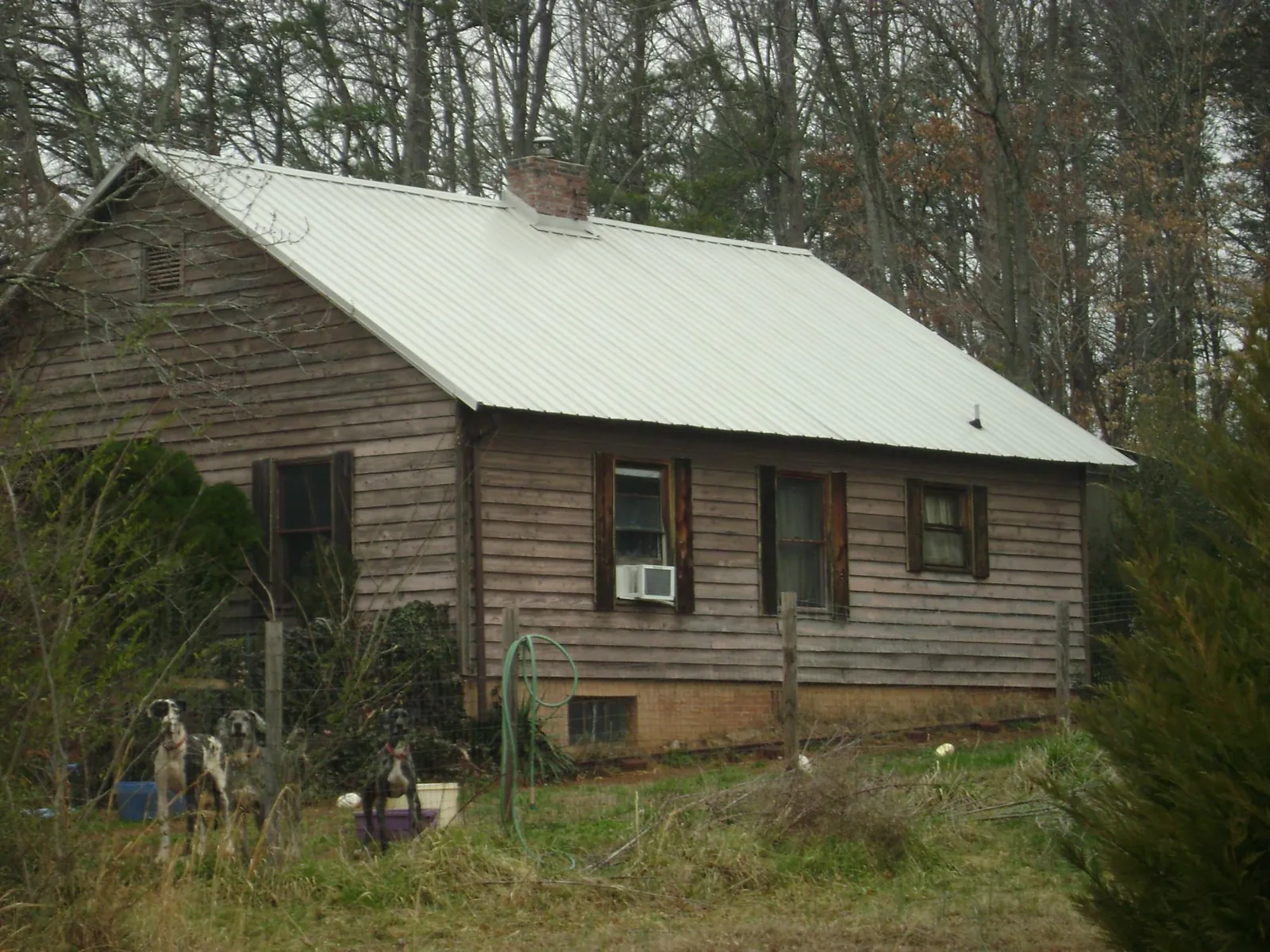White metal roof on an old wood sided farmhouse, from a Metal Roof Installation job in Wattsburg
